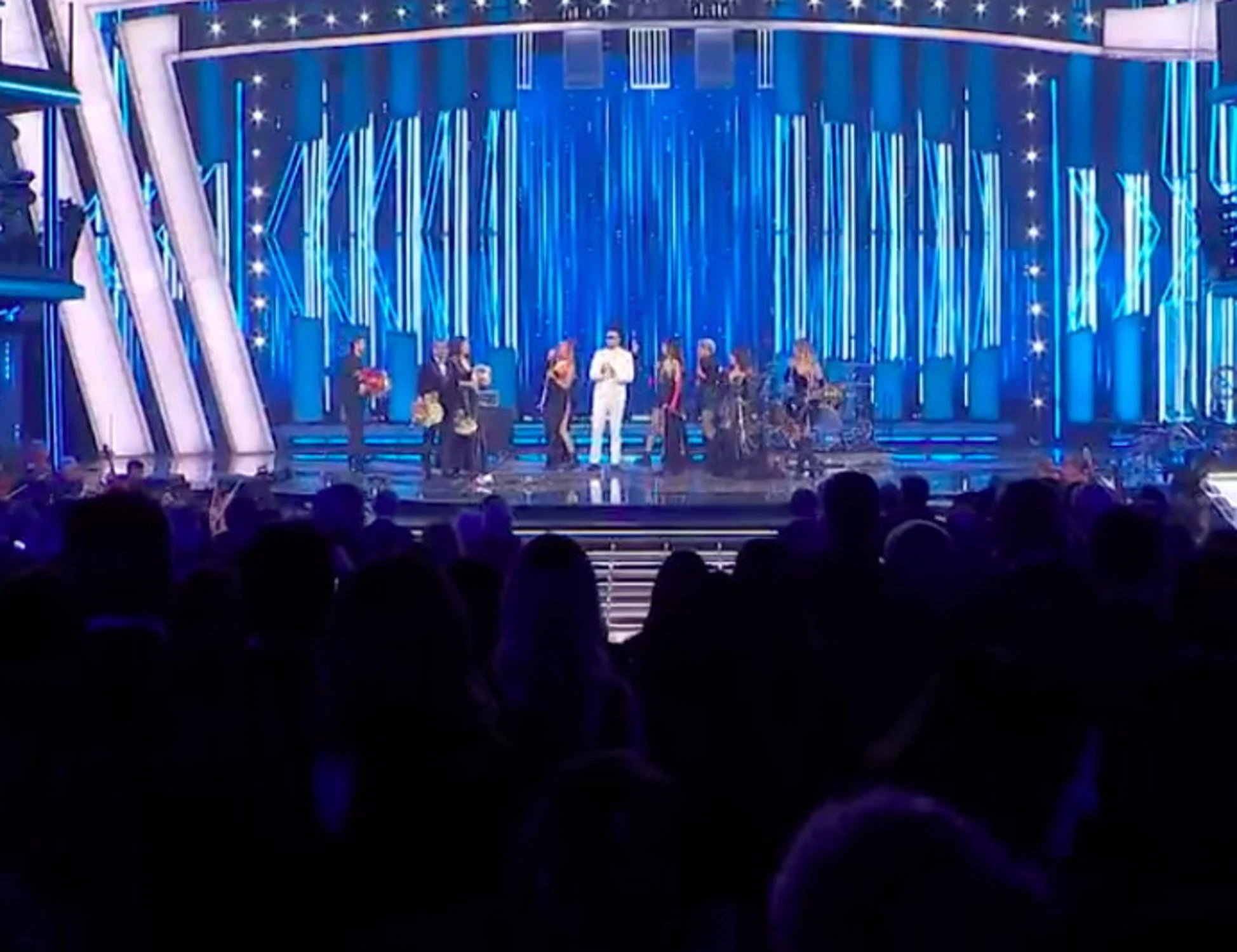 Sanremo 2026, Cristina D'Avena trascina il maestro sul palco. Conti "recupera" con i fiori